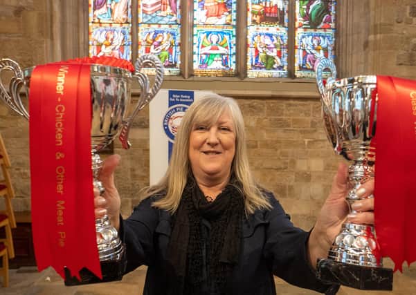 Kath Wallmsley shows off Nice Pie's trophies for two class wins at the British Pie Awards in Melton EMN-201103-103300001