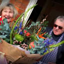 David and Jean Cox with the bouquet they were presented with after retiring from running the butcher's shop at Stathern for 46 years
PHOTO MARTIN FAGAN EMN-201003-132559001