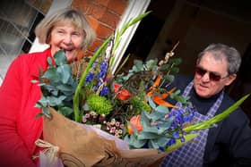 David and Jean Cox with the bouquet they were presented with after retiring from running the butcher's shop at Stathern for 46 years
PHOTO MARTIN FAGAN EMN-201003-132559001