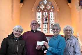 Father Tom McGovern with church members Frances Levett,  Ann Kirby and Sheila Sulley in front of the restored historic stained glass window at Melton's St John's Catholic Church EMN-200318-104403001