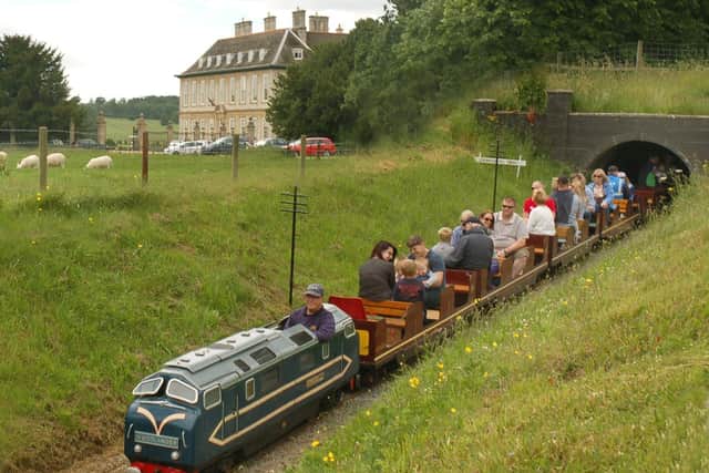 A miniature railway engine chugs its way past the main house of Stapleford Park PHOTO: Tim Williams