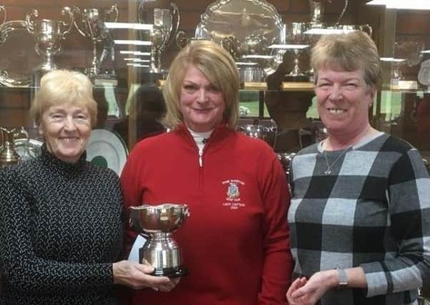 Lady captain Mags McArthur presents the Hi-Low Trophy to Sue Booth and Judy Rawson EMN-200319-120629002