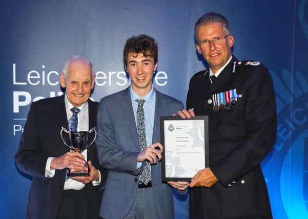 Melton Police Cadet Finley O'Riordan is pictured being presented with his award for being named Leicestershire cadet of the year by Chief Constable Simon Cole EMN-200324-115908001