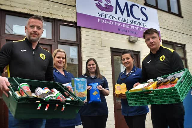 Holwell manager Neil Miller (left) and Ian Bitmead deliver donations from the club and Melton Learning Hub to MCS carers, from left, Claire Mousley, Krystyana Munday, and Gemma Fare EMN-200325-114754002