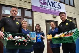 Holwell manager Neil Miller (left) and Ian Bitmead deliver donations from the club and Melton Learning Hub to MCS carers, from left, Claire Mousley, Krystyana Munday, and Gemma Fare EMN-200325-114754002