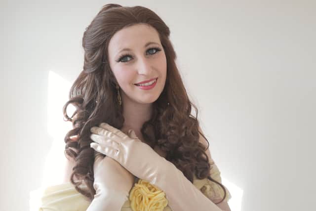 Katie Howett, dressed as Disney's Princess Belle, teaching children with British Sign Language on the Facebook forum EMN-200204-082741001