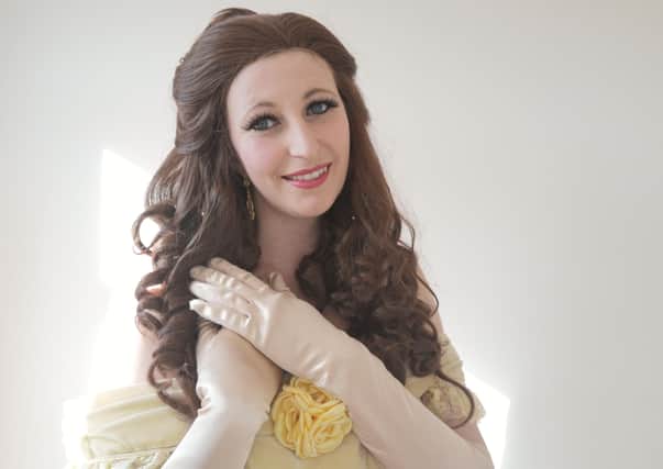 Katie Howett, dressed as Disney's Princess Belle, teaching children with British Sign Language on the Facebook forum EMN-200204-082741001