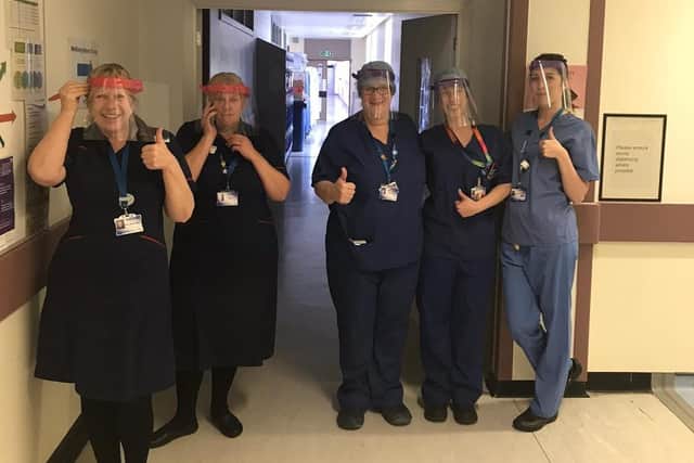 Staff at Leicester Royal Infirmary with masks provided by Oakham School EMN-201104-105319001