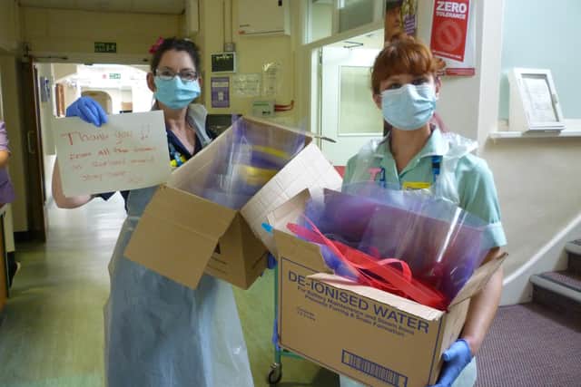 Staff at Rutland Memorial Hospital show off masks provided for them by Oakham School EMN-201104-105404001