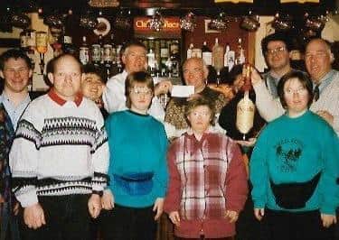 Ernie Pope with staff regulars at the Half Moon showing off a cheque following a fundraising event for Melton Mencap EMN-200420-134655001