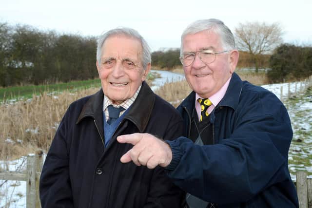 At the wartime Lancaster bomber crash site in 2013, Dennis Kirk (left)  recalls the incident for Barrie Davies (right) who is the son of the only crash survivor Sgt Douglas Davies EMN-200423-130535001