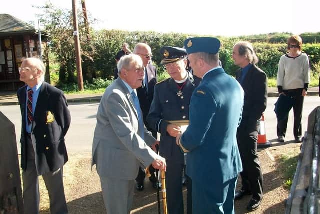 Former air raid warden Dennis Kirk (then aged 92), speaks with The Venerable Air Vice-Marshal Robin Turner CB DL RAF (retd) and Major Conrad Terry LeDrew, of the Royal Canadian Air Force at a 2012 memorial service for the victims of a Lancaster bomber crash near Plungar EMN-200423-130525001