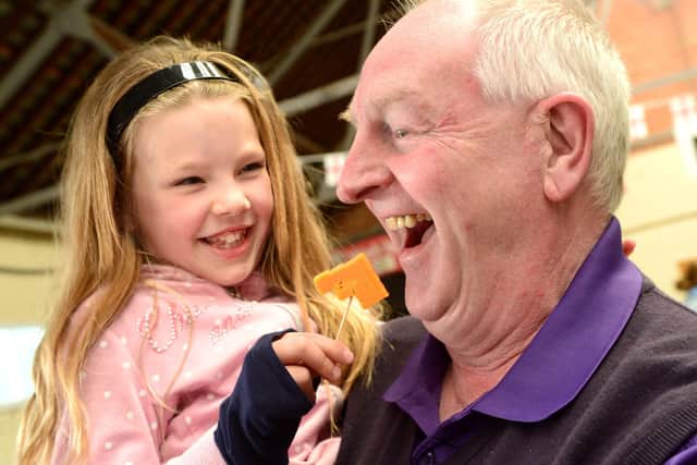 2017 Artisan Cheese Fair : Russell Cook tries samples cheese with his grand-daughter Gracie Ward (7). EMN-200429-163311001