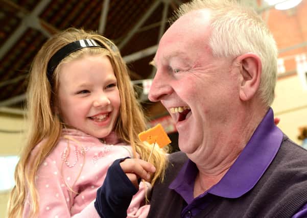 2017 Artisan Cheese Fair : Russell Cook tries samples cheese with his grand-daughter Gracie Ward (7). EMN-200429-163311001