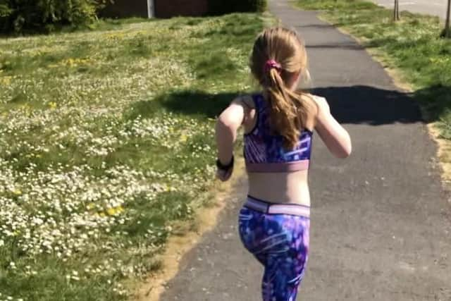 Dorrie McPherson running near her Melton home during her attempt to complete a total distance equivalent to a marathon EMN-200405-152609001