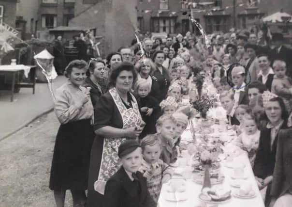 Residents who lived on streets off Burton Road, Melton, pictured during VE Day celebrations in May 1945 EMN-200505-123236001