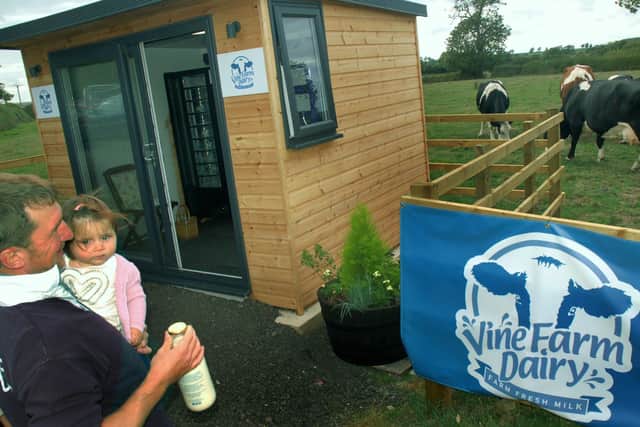 The milk vending machine at Vine Farm, Great Dalby, and the dairy herd in the background EMN-201105-152226001