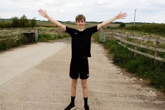 Melton teenager Joe Allen celebrates completing his marathon in aid of the NHS EMN-200519-091845001