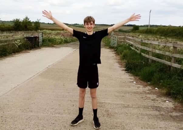 Melton teenager Joe Allen celebrates completing his marathon in aid of the NHS EMN-200519-091845001