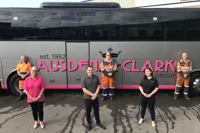 Transport manager Emma Irwin-Nunn pictured this week with Ausden Clark colleagues Adam Frost and Sharon Mallon, with depot mechanics standing behind them EMN-200527-140014001