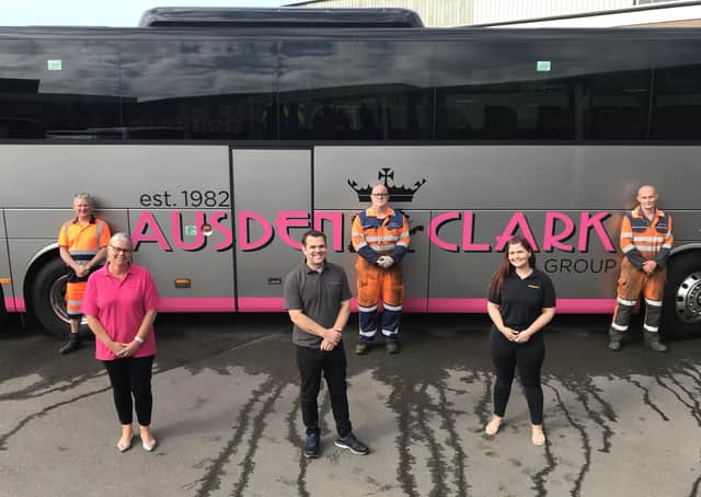 Transport manager Emma Irwin-Nunn pictured this week with Ausden Clark colleagues Adam Frost and Sharon Mallon, with depot mechanics standing behind them EMN-200527-140014001