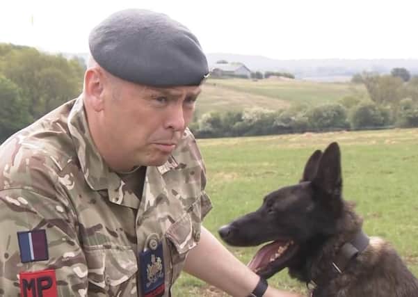 Warrant Officer Jonathan Tanner, chief instructor of the Canine Training Squadron at Melton's DATR camp, with patrol dog, Nicky EMN-200406-191115001