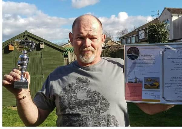 Dave Hutchings, a Syston builder who was treated by the air ambulance after falling from a ladder, shows off his fundraising certificate for the charity EMN-200806-082225001