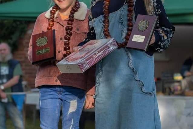 Junior champion Lily Bryan with runner-up Gracie Bryan celebrate during Saturday's Long Clawson Conker Championship EMN-211110-161019001