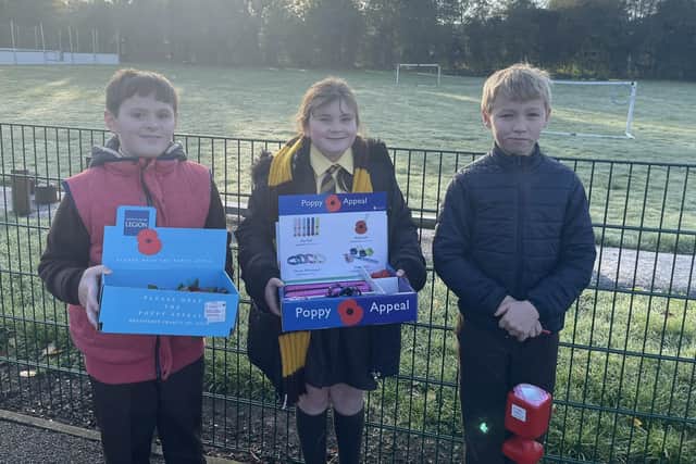 Year Six pupils at Melton's St Francis Catholic Primary School who are collecting fund for the Poppy Appeal by selling poppies and poppy wristbands EMN-210211-145101001