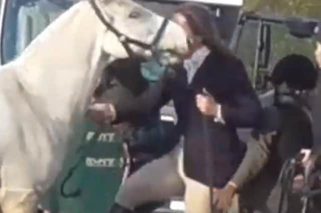 A still from the video posted by Hertfordshire Hunt Saboteurs showing a woman kicking a horse during a meeting of the Cottesmore Hunt EMN-210811-121144001