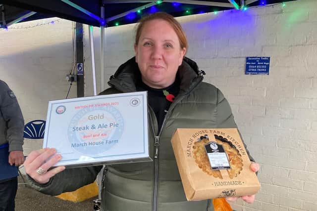 Kelly Stewart shows off one of the award-winning pies baked by March House Farm, at Sunday's PieFest event EMN-211115-105644001
