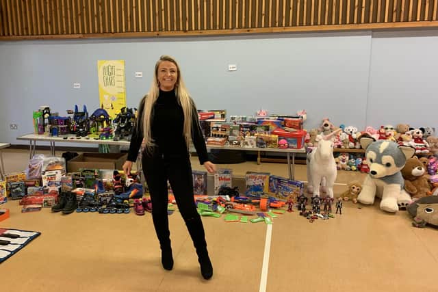 Melton mum Lisa Godber in the hall at The Grove Primary School with some of the hundreds of donated toys she collected for struggling local families last Christmas - she is running another appeal this year EMN-211126-104756001