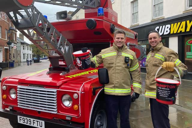 Crew manager Matt McMullan (left) and firefighter Matt Atterbury collect funds for local causes with their Trumpton fire engine at the Melton Christmas Market on Sunday EMN-210512-172246001