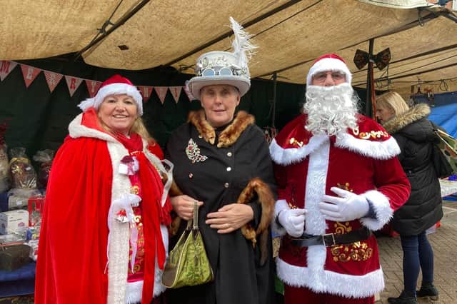 Stallholders David and Sharon Walker in Santa costumes with friend Liz Gay at the Melton Christmas Market on Sunday EMN-210512-172306001