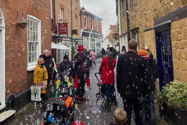 The Bubble Wizard causes a stir in Church Street at the Melton Christmas Market on Sunday EMN-210512-172206001