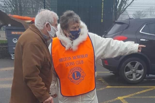 Melton Lions Club volunteers pictured marshalling queues at the town's Covid vaccination centre EMN-211215-083009001