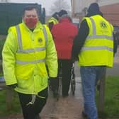 Melton Lions Club volunteers pictured marshalling queues at the town's Covid vaccination centre EMN-211215-083019001