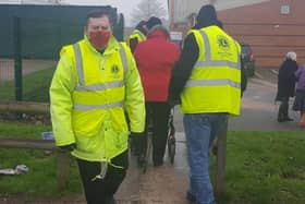 Melton Lions Club volunteers pictured marshalling queues at the town's Covid vaccination centre EMN-211215-083019001