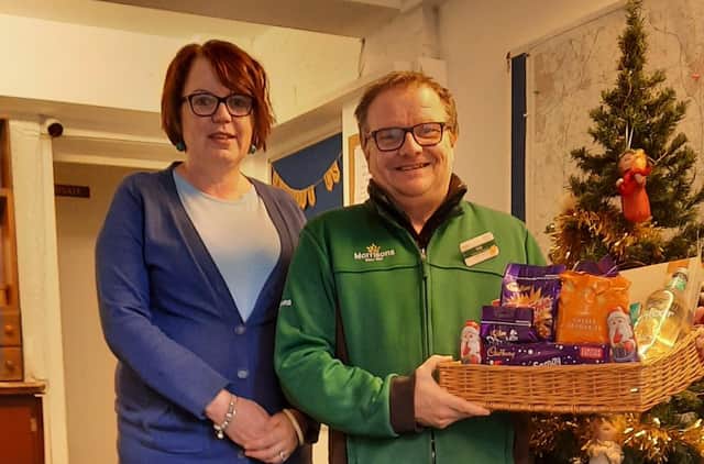 Amanda Heath, manager and founder of Melton and District Money Advice Centre, with Rob Morrish, community champion at Melton Mowbray Morrisons, which has provided a food hamper for the service's 1,000th client EMN-211231-120138001