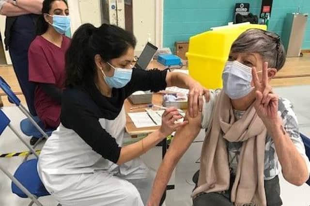Latham House GP Dr Fahreen Dhanji gives a coronavirus jab to a patient at the vaccination centre at Melton Sports Village EMN-211231-101019001