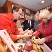Making traditional Melton Mowbray Pork Pies during their Visit to Ye Olde Pork Pie Shoppe in Melton Mowbray... L-R Stephen Hallam, managing director of Dickinson and Morris, Brian Stein, group chief executive of Samworth Brothers, Prince Charles and the Duchess of Cornwall EMN-220124-154543001