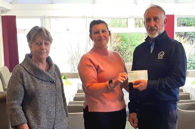 Pictured receiving a cheque for £1,500 is Ruth Johnson of Headway 
together with the 2021 captains, Margaret Samways and David Hirst.