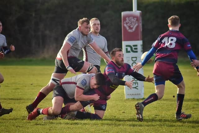 Sam Dennison and Harry Wood ready to help tackler Archie Hutchinson. Photo: Tim Wiliams
