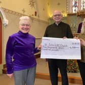 Frances Levett (left) presents a fundraising cheque to Father Tom McGovern for St John's Catholic Church in Melton, with fellow church members Ann Kirby and Sheila Sulley EMN-220213-181203001