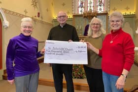 Frances Levett (left) presents a fundraising cheque to Father Tom McGovern for St John's Catholic Church in Melton, with fellow church members Ann Kirby and Sheila Sulley EMN-220213-181203001