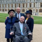 Matt Hampson and family members at Windsor Castle shortly after he was presented with his OBE by Princess Anne EMN-220215-111540001