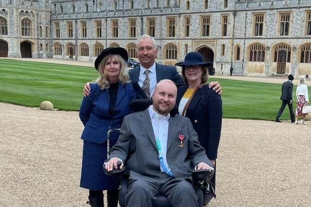 Matt Hampson and family members at Windsor Castle shortly after he was presented with his OBE by Princess Anne EMN-220215-111540001