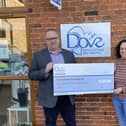 Martin Scholes, of Scholes Wealth Management, presents a cheque to Jenny Hendry, of Dove Cottage Hospice, as a charity donation EMN-220221-102331001