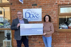 Martin Scholes, of Scholes Wealth Management, presents a cheque to Jenny Hendry, of Dove Cottage Hospice, as a charity donation EMN-220221-102331001