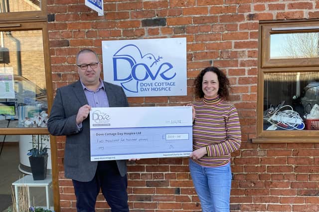 Martin Scholes, of Scholes Wealth Management, presents a cheque to Jenny Hendry, of Dove Cottage Hospice, as a charity donation EMN-220221-102331001